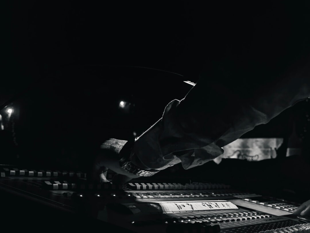 Vision mixing desk with camera switching buttons glowing in a dark room